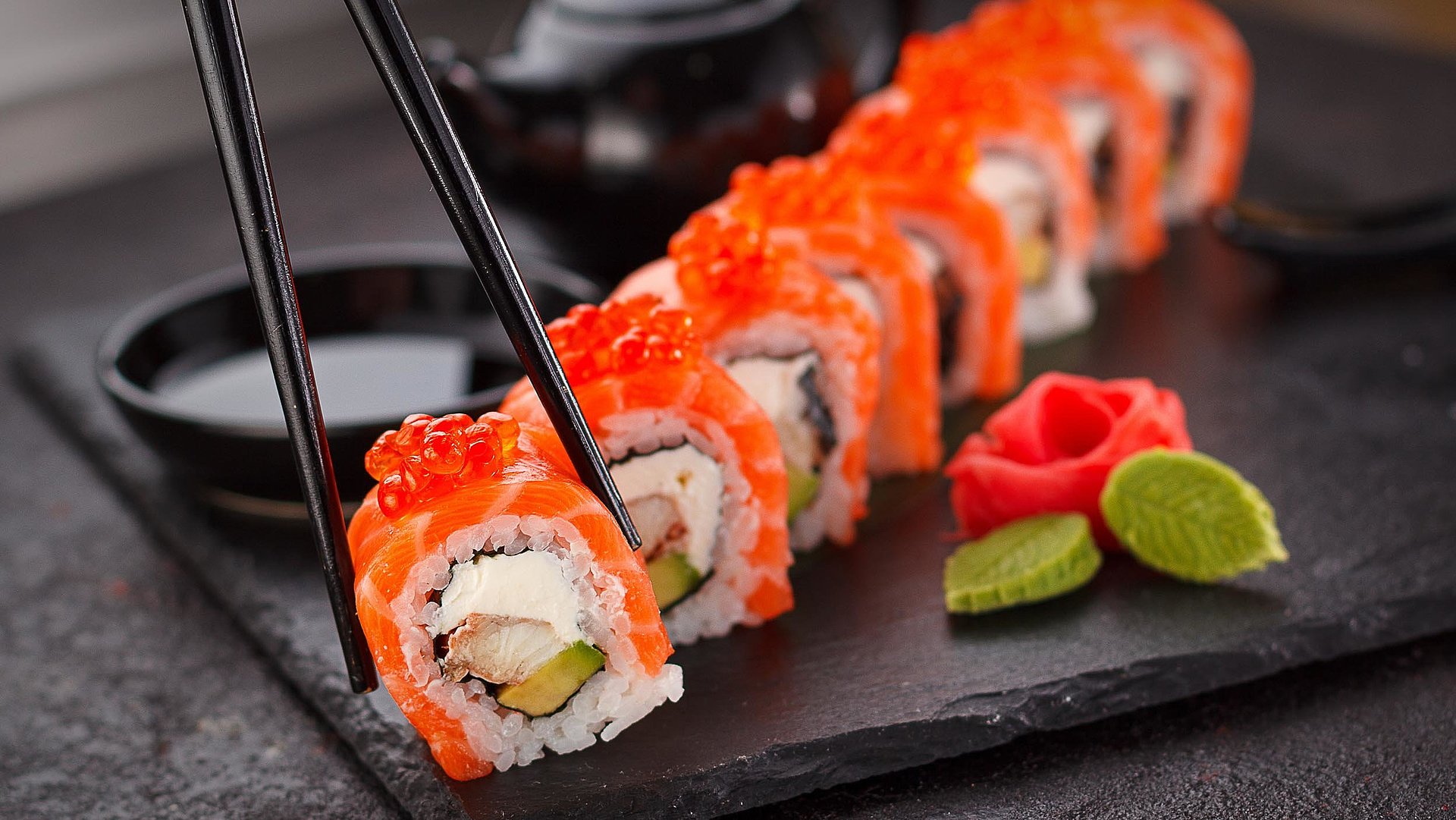 Cateringservice im Fichtelgebirge - Person nimmt eine Sushi mit Stäbchen von Sushiplatte