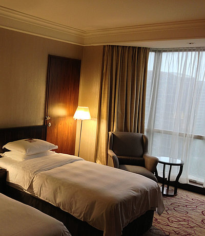 Pauschalangebote Unterkunft in Franken - sehr ordentliches Hotelzimmer mit zwei Betten, warmer Nachtlampe und Gardinen