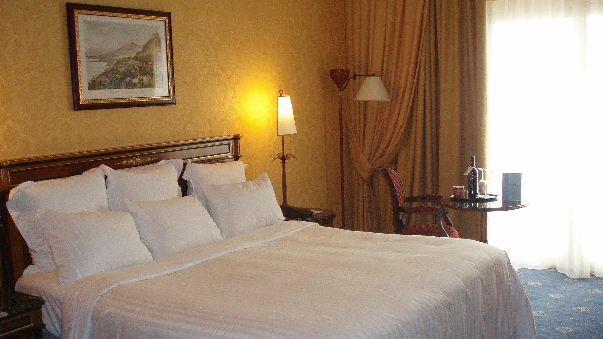 Übernachten im Video Unterfranken - sehr ordentliches Hotelzimmer mit großem Bett, warmer Nachtlampe und mittelgroßem Wandgemälde