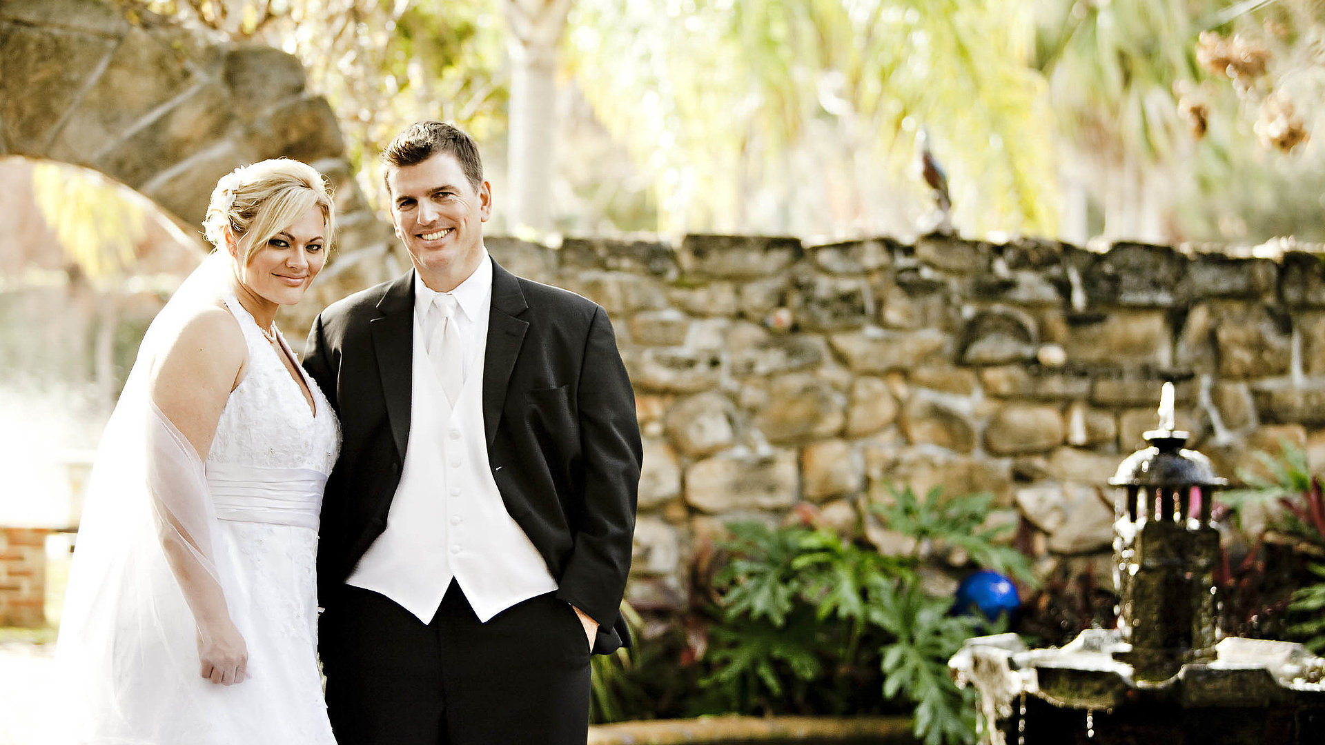 Heiraten im Ostallgäu - Ehepaar im Garten, beide lächeln in die Kamera